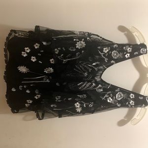 KobiHalpern cold shoulder blouse with white embroidered flowers.